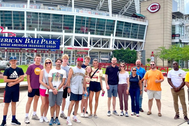 a group of people standing in front of a crowd posing for the camera