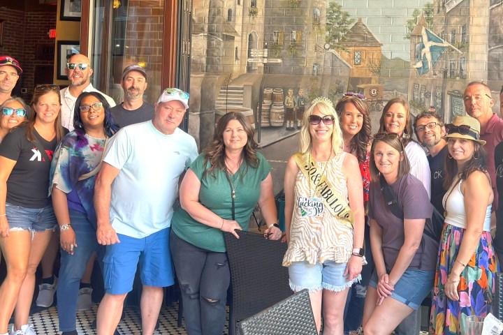 a group of people standing in front of a crowd posing for the camera